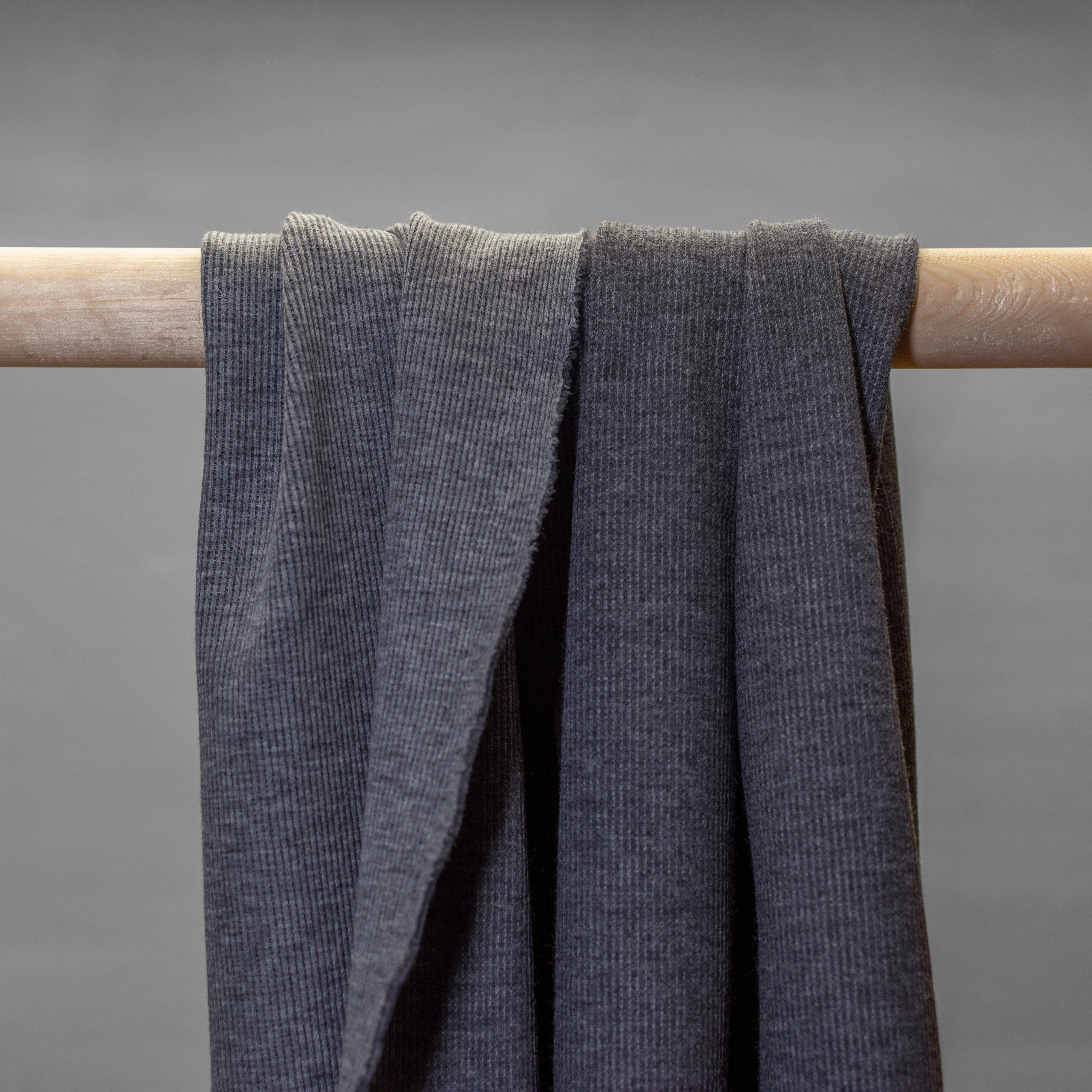  Grey rib knit jersey hanging in folds.