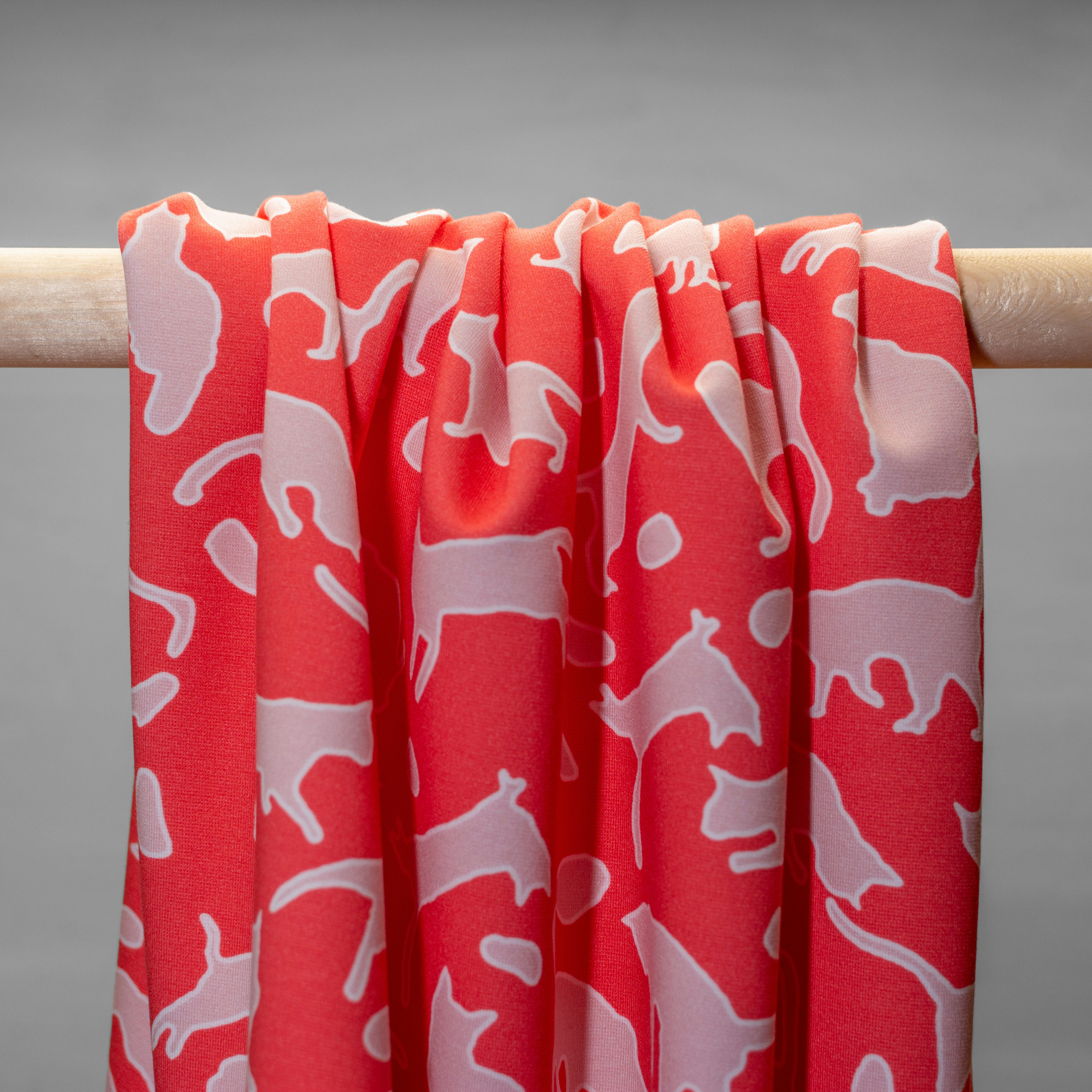 Jersey in pink cat print hanging in folds.
