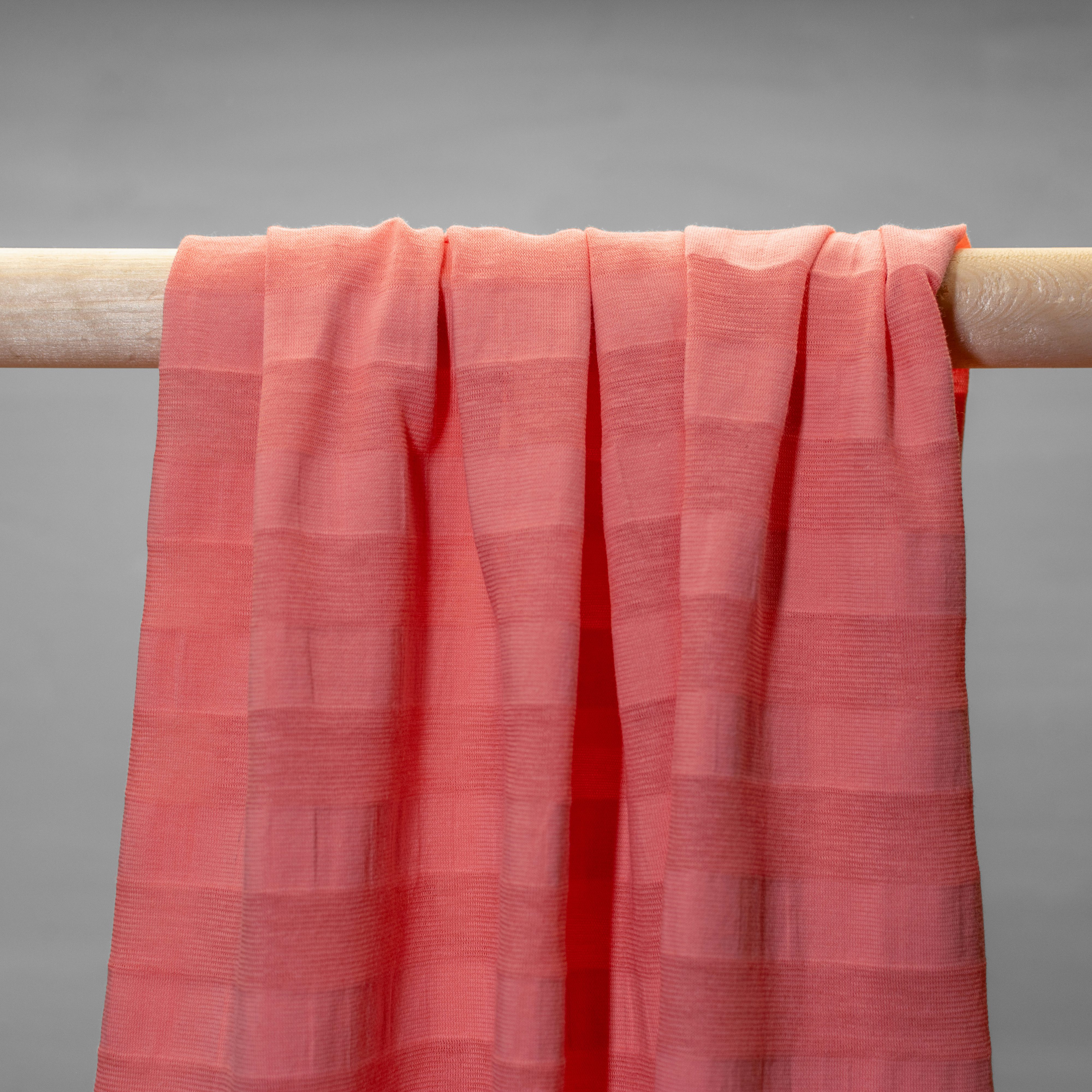 Pink striped  jersey hanging in folds.