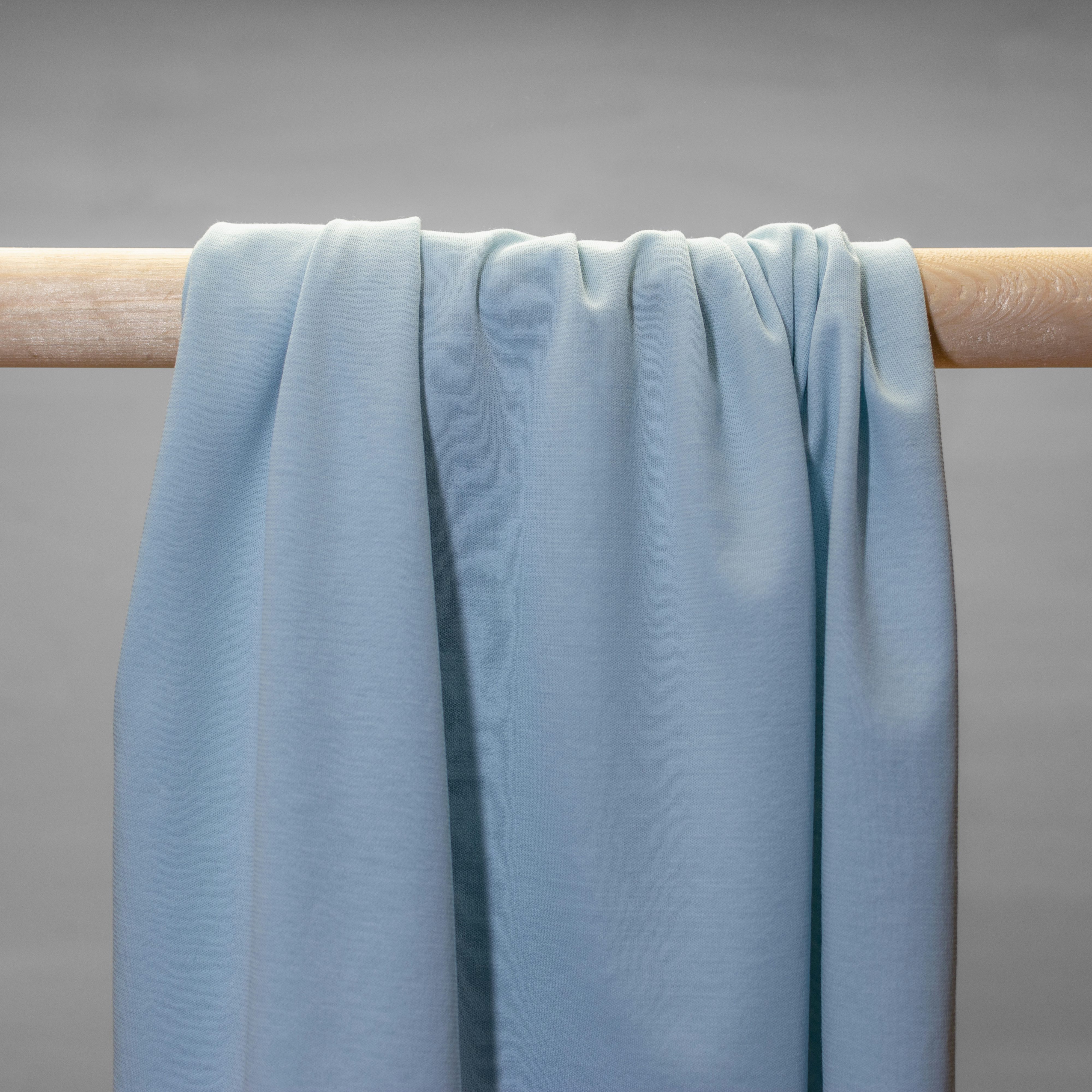 Powder blue  jersey hanging in folds.